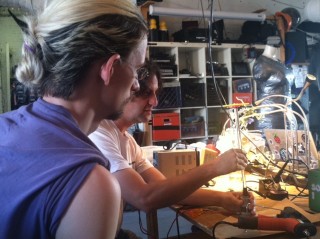 Instrument-maker Ranjit Bahatnagar and Jordan Morley working on the singing garden